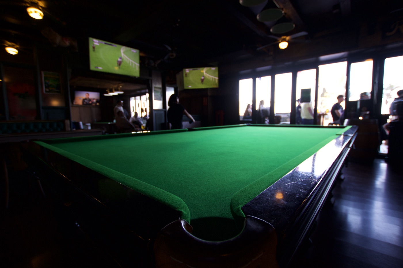 Snooker table with sports on the screens